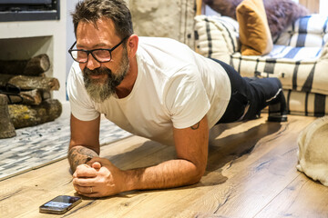 Adult man doing fitness workout exercise at home doing plank on the floor