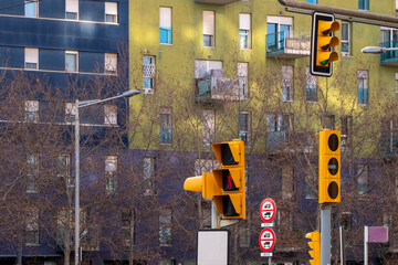 City street with multiple traffic lights and a colorful urban backdrop.