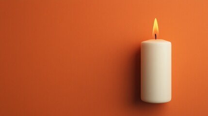Elegant Candle with Flame on Warm Orange Background for Cozy Atmosphere and Relaxing Mood