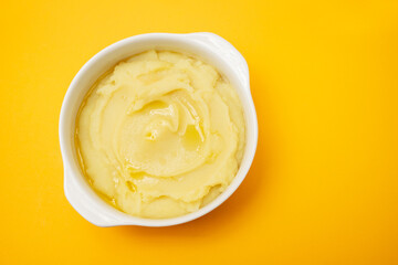 Mashed potato with olive oil in white bowl