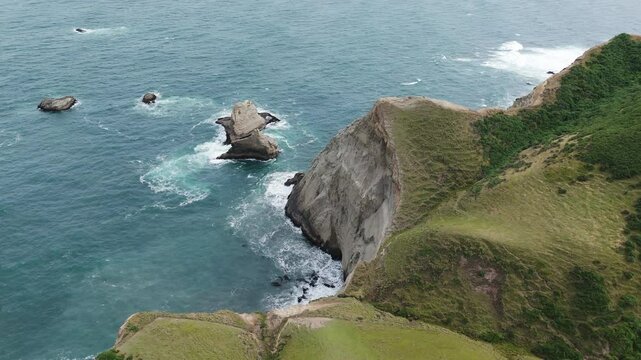 Spectacular coastal cliffs with ocean waves crashing in Chonchi, Chiloe Island, Chile.