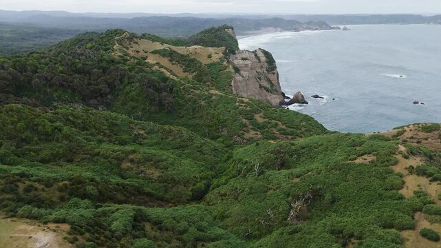 Aerial view of the cliffs and coastline near Muelle De Las Almas, a unique place in Chonchi, Chiloe Island, Chile. Dolly Forward