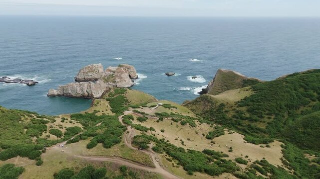 Aerial view of the stunning Muelle De Las Almas in Chonchi, Chile, showcasing the dramatic coastline and the vastness of the Pacific Ocean. push forward