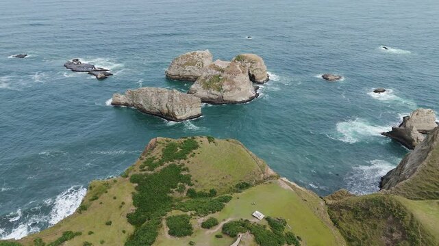 Stunning aerial perspective capturing the dramatic beauty of Muelle De Las Almas and the rugged coastline near Chonchi, Chile, a captivating travel destination