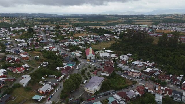 Drone capturing Chonchi, a charming town nestled in the picturesque landscapes of Chiloe Island, showcasing its vibrant architecture and the prominent church