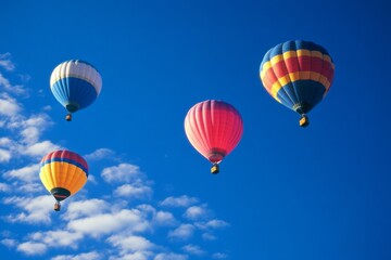 Obraz premium Vibrant hot air balloons float against a clear blue sky, epitomizing adventure and the joy of serene exploration.