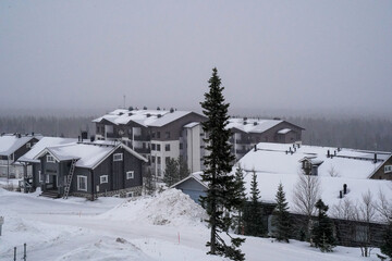 Snowy winter town with cozy wooden houses.