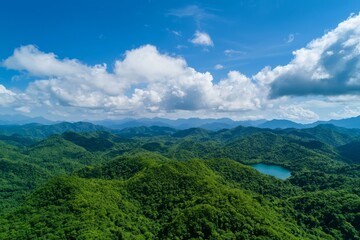 Naklejka premium World Environment Day is symbolized by the image of green mountains and beautiful clouds set against a blue sky