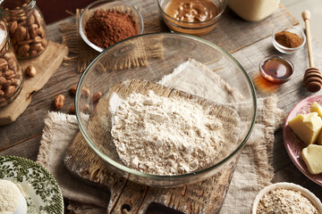 Whey protein powder, ground oat flakes, nut butter, raw cacao and maple syrup - ingredients for homemade protein chocolate bars