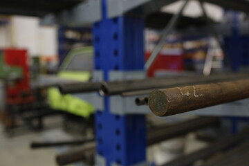Industrial metalworking with blueprints in the background, suggesting a sense of planning or design.