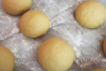 round dough for making steamed buns in home kitchen, gluten yellow dough from sweet potato 