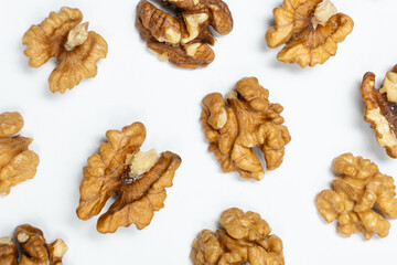 Walnut kernels, white background, top view.
