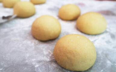 round dough for making steamed buns in home kitchen, gluten yellow dough from sweet potato 
