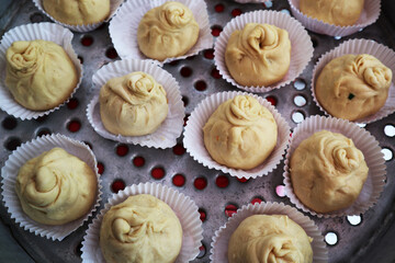 home made uncooked bun dough on the steamer in the kitchen 