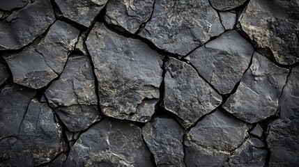 Fractured Black Rock Wall with Deep Cracks.