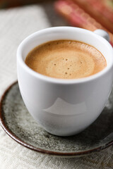 Cup of coffee on wooden background. Soft focus.