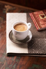 Cup of coffee on wooden background. Soft focus.