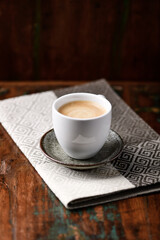 Cup of coffee on wooden background. Soft focus.