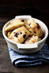 Dumplings with potato and cottage cheese stuffing (pierogi). Wooden background. Copy space.