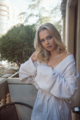 Portrait of a beautiful bridesmaid sitting in a hotel on her wedding morning