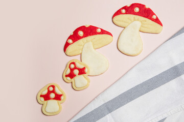 Thin homemade biscuits. Woodland red mushroom with white dots. Sugar cookies for party, Easter or baby shower. 