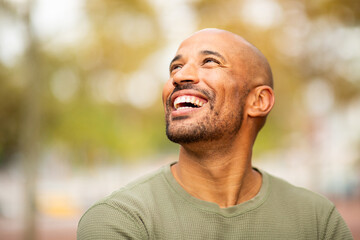 portrait of a happy, confident man smiling outdoors