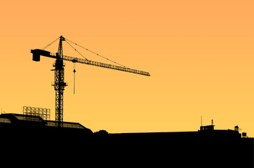 Construction crane silhouette at sunset.