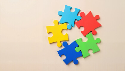 Colorful puzzle pieces on a neutral surface symbolizing unity and inclusivity