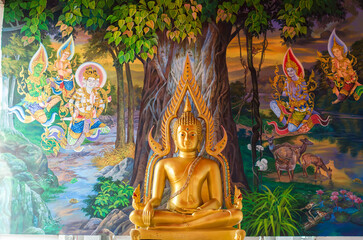 Fototapeta premium Golden Buddha with colorful mural backdrop