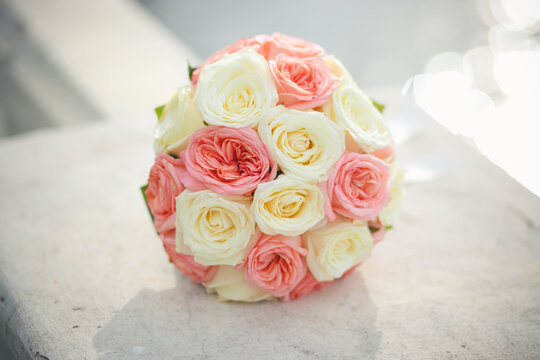 Very beautiful wedding bridal bouquet, made of white roch and austoma, and yellow daisies, green casting of eucalyptus. Wedding, engagement. Bride and groom. Bride's wedding bouquet.