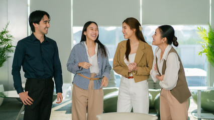 Engaged group of professionals laughing and discussing in modern office Leader Teamwork stratup