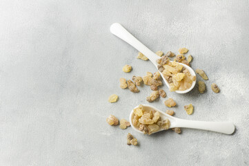Natural organic frankincense or olibanum aromatic resins on light gray background, used in incense...