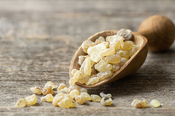 Natural organic frankincense or olibanum aromatic resins on wooden background, used in incense and...