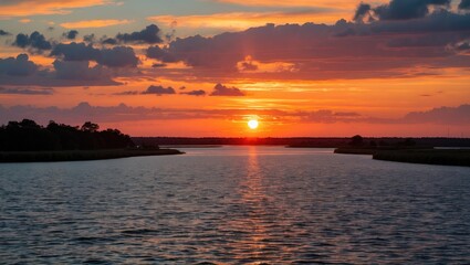 Fototapeta premium Serene Sunset Reflection Over Waterway at Hunting Island Natural Beauty