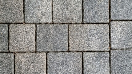 Fototapeta premium A close-up view of gray stone pavers forming a durable and textured surface, ideal for outdoor pathways and landscaping.