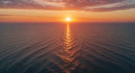 Fototapeta premium Aerial View of Vibrant Sunset Over Calm Sea Horizon with Reflections Creating a Serene Seaside Atmosphere for Nature and Travel Themes