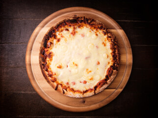 Pizza margherita on wooden background. Soft focus. Top view. Close up.	