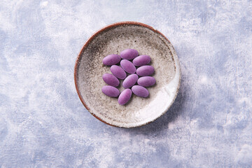 Lutein tablets. Dietary supplement on wooden background. Soft focus. Top view. Close up. Copy space	