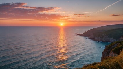 Fototapeta premium Serene Coastal Sunset over Calm Waters with Vibrant Sky Reflections and Coastal Cliffs in the Background