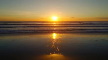 Crédence de cuisine Beige Golden sunset over the ocean, with the sun dipping below the horizon, casting a reflection on the water and painting the sky with fiery oranges and pinks.  © arhendrix