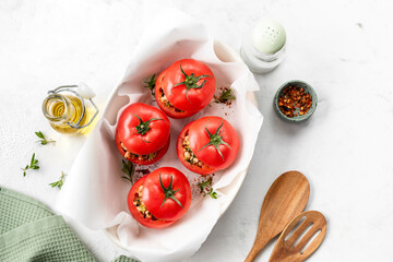 Turkey-stuffed tomatoes on a white background