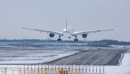 Airplane landing  at the airport in winter