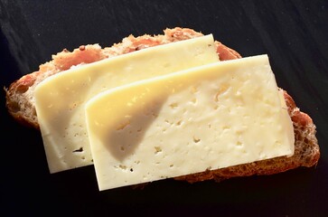 breakfast sandwich with cheese in hand