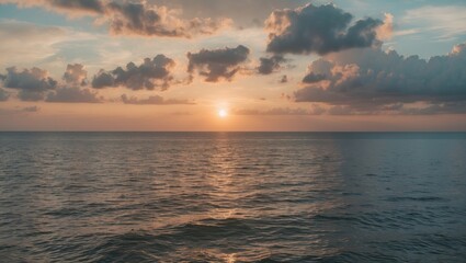 Fototapeta premium Serene Sunset Over Ocean Waters Creating Warm Glow and Peaceful Atmosphere With Soft Clouds and Empty Space for Text in the Sky