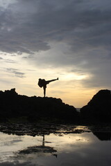 silhouette of a man jumping on the beach