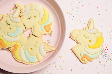 Thin homemade biscuits in unicorn shape. Sugar cookies for children, birthday party, Easter or baby shower.