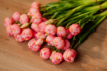 tulips bouquet on the floor. flowers for women's day. pink flower buds for march 8
