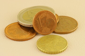 Metal Euro coins on the texture of genuine leather. Close-up. Macro. Soft focus.