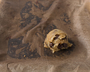 scoops of chocolate chip cookie dough on a baking sheet, homemade chocolate chip cookie dough,...
