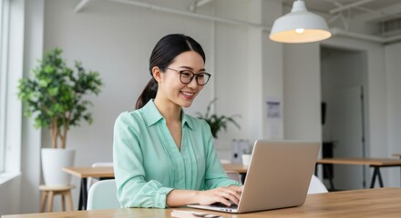 Smiling Asian Woman Working on Laptop